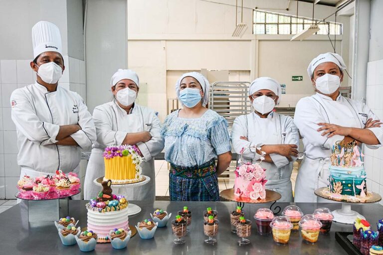 Grupo de mujeres reposteras frente a sus creaciones culinarias